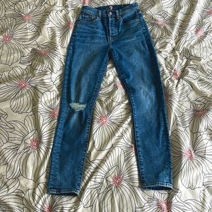 7 for all man kind high waisted skinny jeans with knee rip.